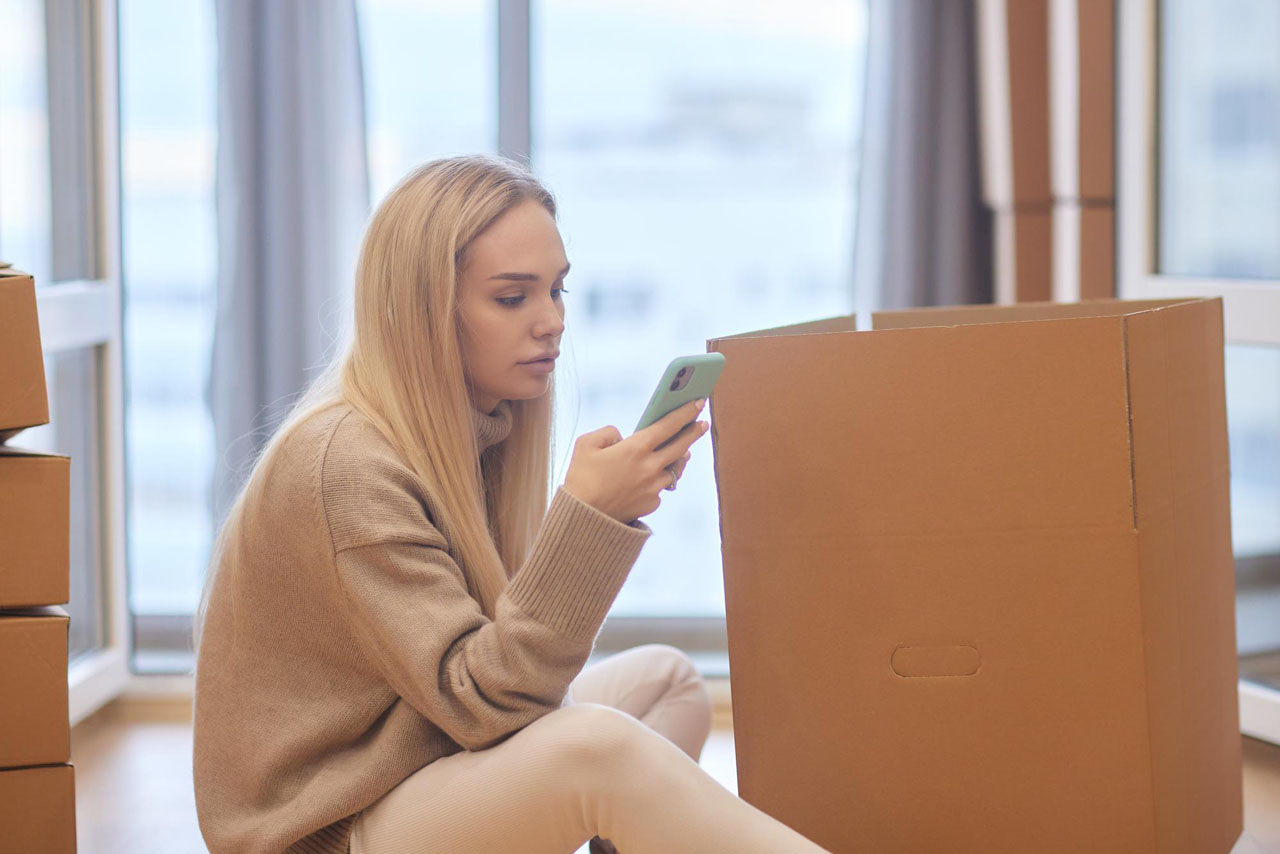 Young woman moving new place repair concept happy young woman with many cardboard boxes sitting 152904 19942